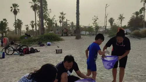 Dubai residents get free swimming lessons at Jumeirah beach by participating in beach clean-up 